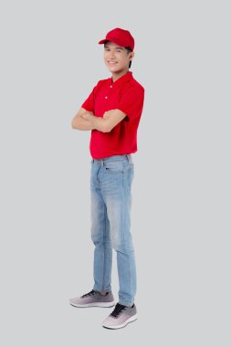 Young asian man in uniform red and cap standing arms crossed with confident isolated on white background, employee or dealer, courier and delivery, deliveryman and expression, logistic and cargo.