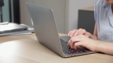 Young caucasian woman sitting and using laptop computer planning for success in modern office, businesswoman typing and watching notebook with confident, employee working on desk, business concept.