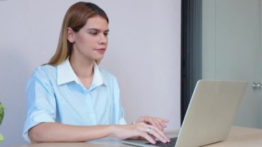 Genç iş kadınının ev ofisinin oturma odasında dizüstü bilgisayar kullanması, iş kadınının internet, girişimci ya da serbest çalışma, iş ve iletişim için dizüstü bilgisayar kullanması.