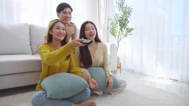 Bir grup Asyalı genç arkadaş evlerinde rahat bir oturma odasında birlikte televizyon izliyor, gülüyor ve eğleniyorlar. Televizyon izliyorlar, hem de rahat, yaşam tarzı ve eğlence ile..