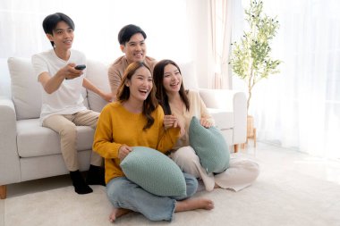 Bir grup Asyalı genç arkadaş evlerinde rahat bir oturma odasında birlikte televizyon izliyor, gülüyor ve eğleniyorlar. Televizyon izliyorlar, hem de rahat, yaşam tarzı ve eğlence ile..