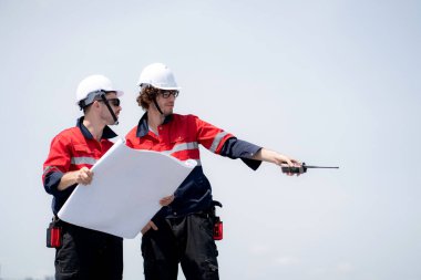 Güneş enerjisi sistemini kontrol eden iki mühendis, kurulum güneş paneli, yenilenebilir enerji ve sürdürülebilir teknoloji, temiz elektrik, sanayi ve güneş hücresi planlama projesini birlikte inceliyor..