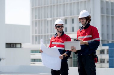 Güneş enerjisi sistemini kontrol eden iki mühendis, kurulum güneş paneli, yenilenebilir enerji ve sürdürülebilir teknoloji, temiz elektrik, sanayi ve güneş hücresi planlama projesini birlikte inceliyor..