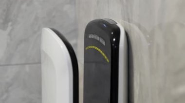 Close-up of a new high-tech hand dryer in the toilet or bathroom