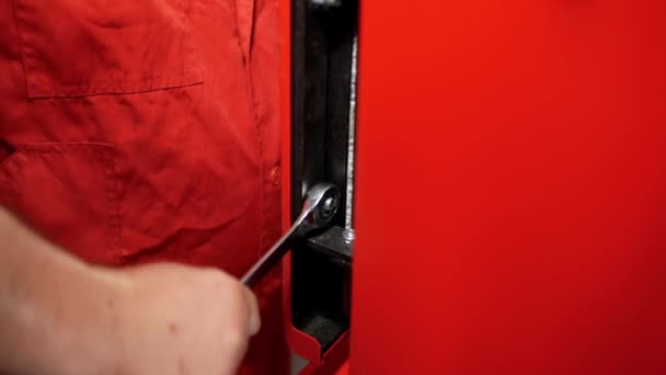 Close Worker Hand Red Robe Who Tightens Nut Wrench Heavy — 图库视频影像