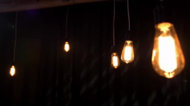 Karanlık bir odada dekoratif cam retro parlak ampuller. Bir restoranda ya da fotoğraf stüdyosunda romantik bir atmosfer..