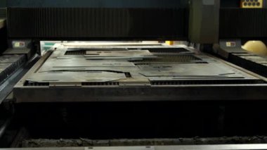 İşlenmemiş bir metal levha CNC plazma kesicisine saplanıyor. Metal fabrikası. Demir parçaları kesmek için otomatik lazer makinesi. Metal işleri.