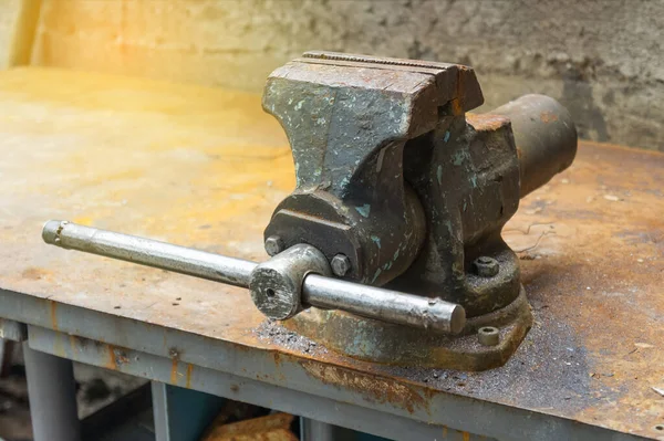 old rusty vise grip on work bench