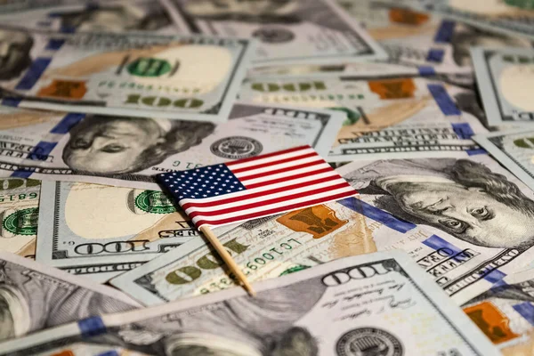 stock image American Flag on a Bed of Dollar Bills.