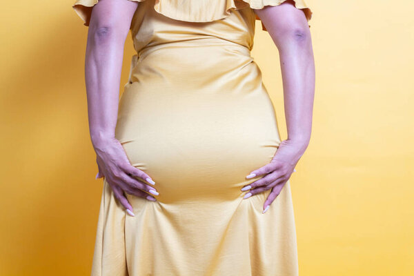 close up shot of latin woman holding her butt provocatively