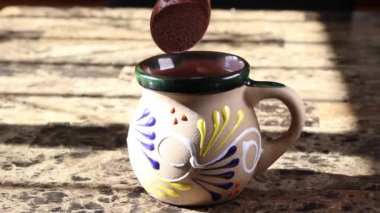 pov view of man making coffee in traditional mexican cup