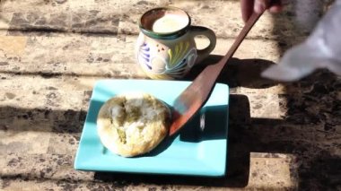 pov view of person serving tlacoyos at breakfast. Mexican food. traditional cup of coffee