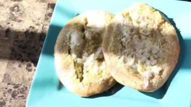 Mexican food slider at breakfast. tlacoyo in green sauce