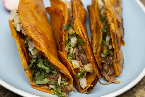 stock image close up of 3 crispy birria tacos. Mexican food