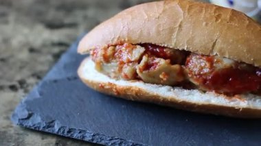 slow motion slider of tamale torta in red sauce. Mexican food. sandwich