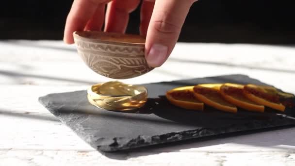 Hand Placing Mezcal Shot Traditional Bowl Taking Orange Slice — Vídeo de Stock