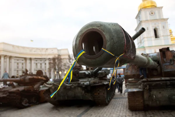 broken equipment with a Ukrainian ribbon on the square in the city