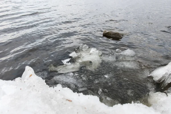 stock image melted ice on the bank of the river. early spring