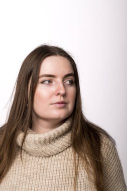 A 25-year-old woman in a light gray sweater looking off to the side, against a white background. Ideal for themes of fashion, casual style, or a neutral lifestyle concept clipart