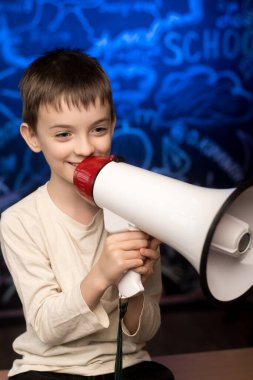 Boy holding a megaphone, ready to announce something in a school-themed setting. The vibrant chalkboard background emphasizes education, creativity, and leadership. Ideal for learning and communication topics clipart