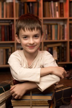 Cheerful child surrounded by bundles of books in a warm, academic environment, symbolizing the excitement of discovery and knowledge. clipart