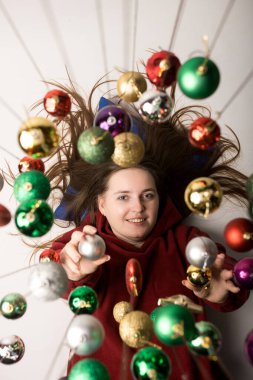 Creative Christmas photo with vibrant ornaments and a happy woman. Celebrate the joy of the holidays with this unique festive image clipart