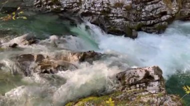 Dramatik kanyon manzarası: Şelaleden bir nehir, güneş ışığı ve gölgelerle dolu dar bir geçitten akar. Yüksek kalite 4k görüntü