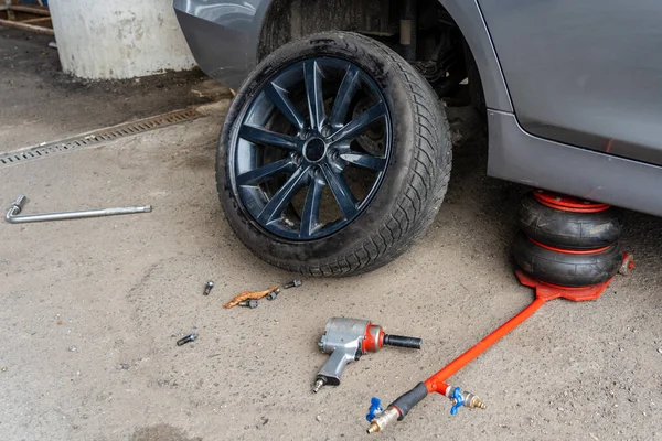 A Close up of changing car tyre. Car tire fitting