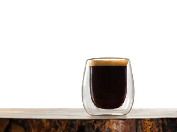 Glass of coffee on wooden table with isolated background