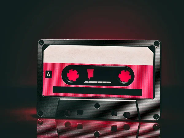 Vintage audio cassette on red background