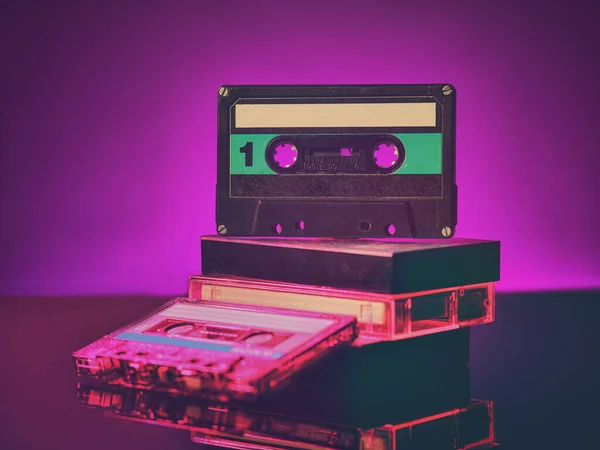 Vintage audio cassettes on the table in neon light