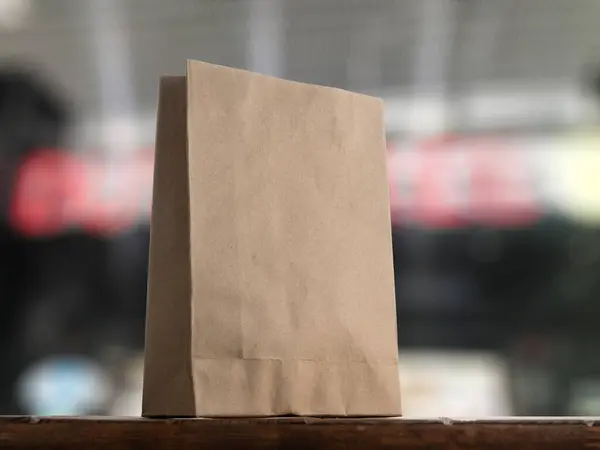 Paper Bag in Front of Storefronts
