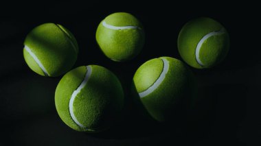 Canlı Yeşil Tenis Topları Dramatik Karanlık Minimalist Kompozisyonda Yüzüyor