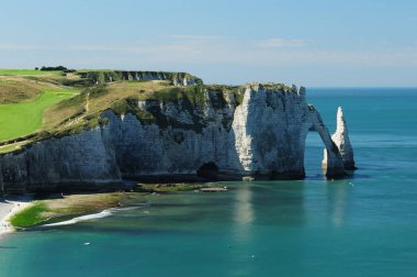 The White Cliffs Of Falaise d'Aval In Etretat Normandy France On A Beautiful Sunny Summer Day With A Few Clouds In The Sky