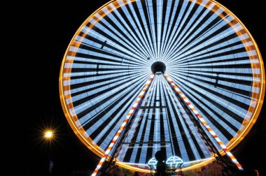 Brightly Lit Ferris Wheel In Honfleur Normandy France On A Beautiful Summer Evening