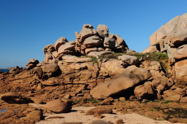 Rocks Like Faces On The Red Rock Coast In Ploumanach In Bretagne France On A Beautiful Sunny Summer Day With A Clear Blue Sky