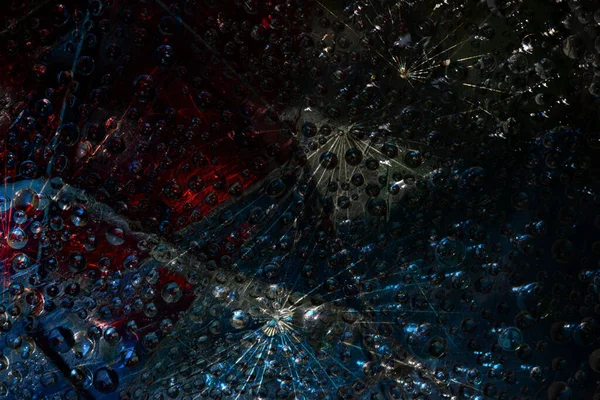 Space abstraction. Blue-black spheres are illuminated by rays of lights and are located against a red-black background. 3D render.