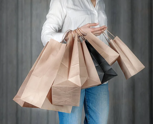 The girl holds craft bags in her hand. Shopping concept