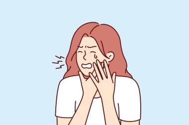 Diş ağrısı çeken ve yanak tutarak ağlayan bir kadının dişçi kliniğinden yardıma ihtiyacı var. Kız diş eti iltihabı, mide iltihabı ve karın ağrısı nedeniyle diş ağrısı çekiyor.