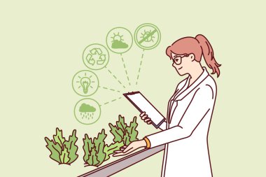 Kadın hidrofonik bitki çiftliğinde çalışıyor. Biyolojik araştırma laboratuvarında bitki yetiştiriyor. Beyaz önlüklü mutlu kız bilimsel çiftlikte çalışan yararlı özellikleri olan otlar üzerinde çalışıyor..