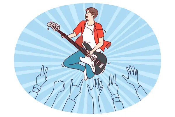 stock vector Crowd enjoying concert of male artist. Man performer playing guitar on stage for audience. Flat vector illustration.