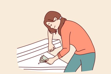 Kadın parayı yatağın altına saklar ve gülümser, parayı güvende tutar ve büyük bir alışveriş için para biriktirmek ister. Banka mevduatlarına güvenmeyen bir kızda finansal okur yazarlık eksikliği kavramı