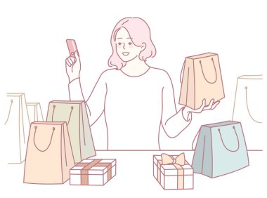 Bavulları ve kredi kartı olan neşeli bir müşteri bir dizi renkli hediyelerden hoşlanır. Alışverişi kucakla