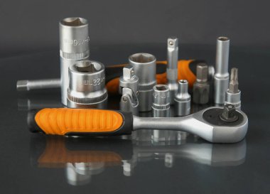 a set of hand tools on a black background