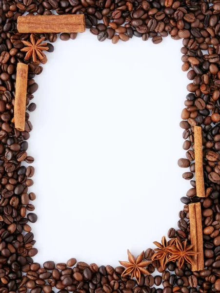 Coffee beans and spices on a white background with space for text