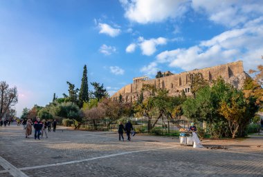 Athens, Greece - January 7 2023: View of Dionysiou Areopagitou pedestrian street on a sunny afternoon, with the Acropolis on the background. clipart