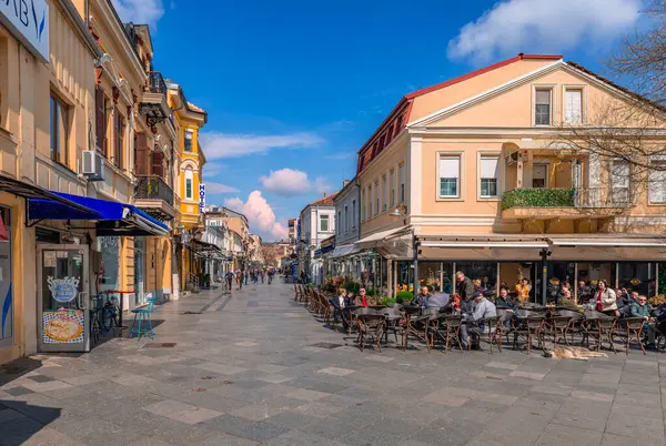 stock image Bitola, North Macedonia - March 16 2024: View of Shirok Sokak with people in sidewalk cafes enjoying a sunny day. Shirok Sokak is a busy pedestrian street and a landmark of the city.