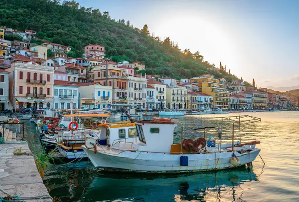 stock image Gytheio, Greece - June 27 2024: The waterfront of the town, with fishing boats and neoclassical houses at the sunset.