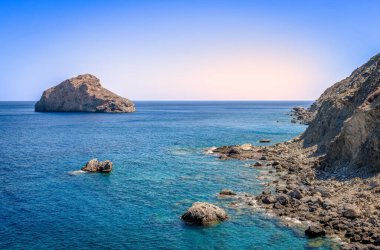 Scenic seascape in Amorgos Island. Picture taken from the beach of Agia Anna, a small rocky beach famous for the scenes in the movie The Big Blue. In Cyclades, Greece. clipart