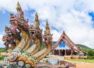 Colorful head of king naga thai dragon statues at Wat Pa Huay Lad public temple landmark of Phu Ruea, Loei, Thailand clipart